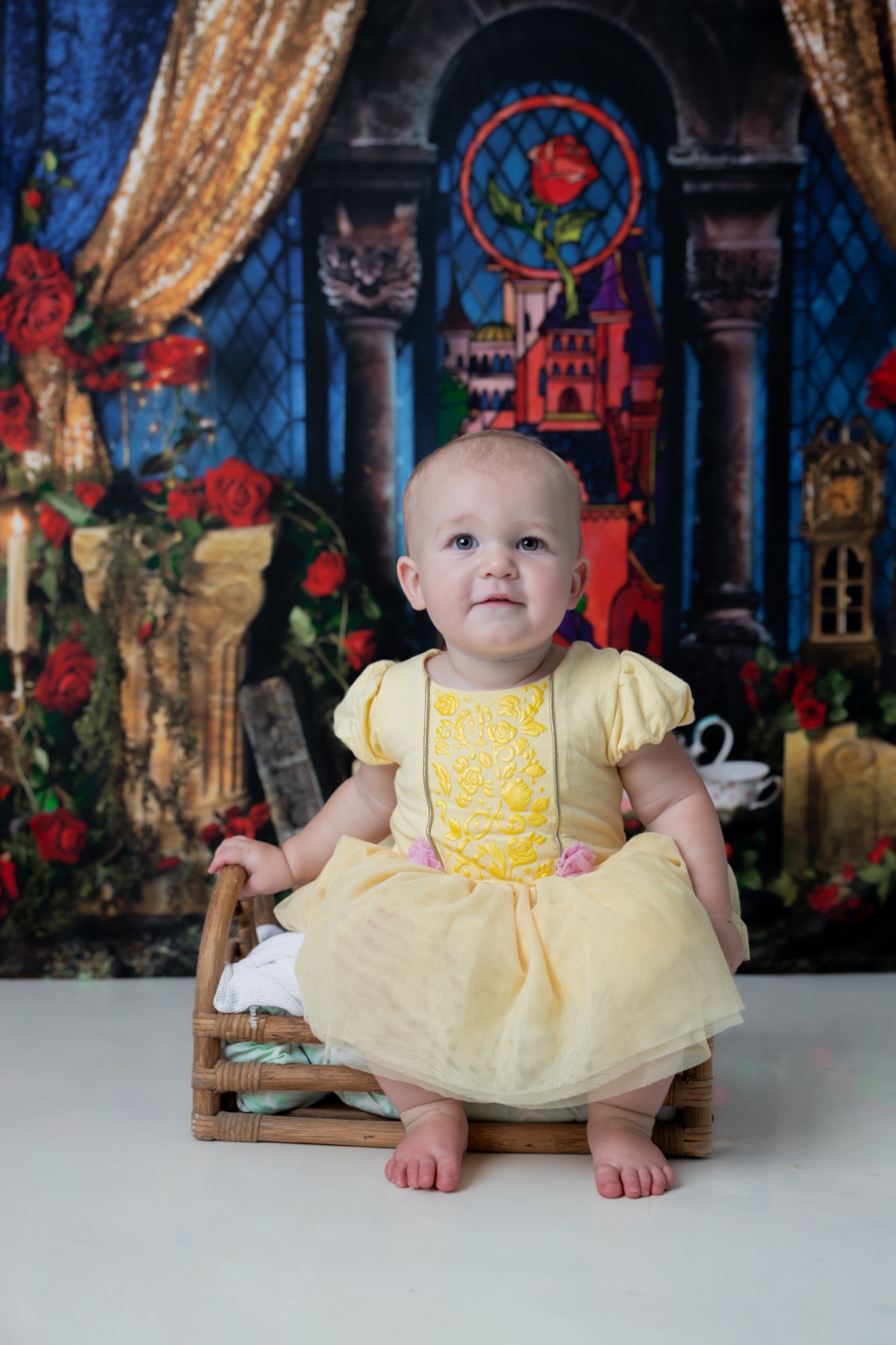 Child seated on a small chair in a yellow dress